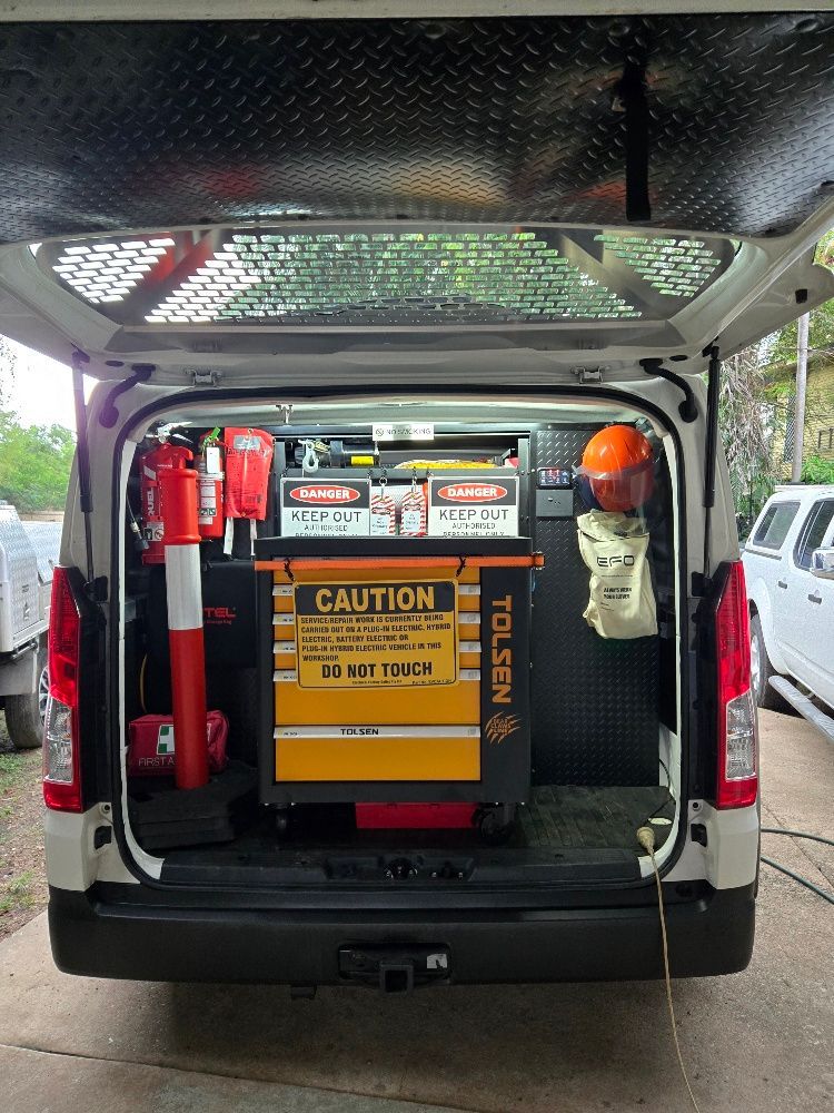 Open back of a utility van filled with tools and safety equipment; orange and red colours dominate. — Cool Cars NT in Anula, NT