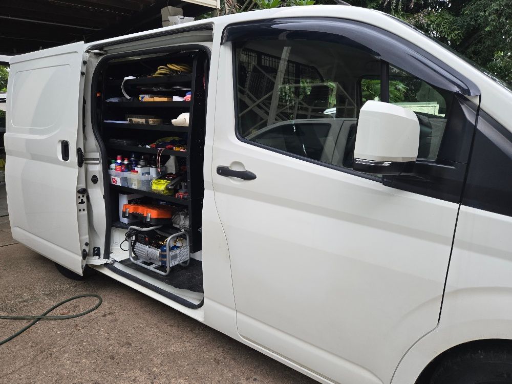 White work van with side door open, showing interior shelving and equipment. — Cool Cars NT in Anula, NT