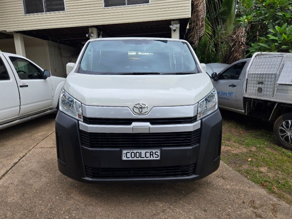 White Toyota Hiace van parked with license plate reading