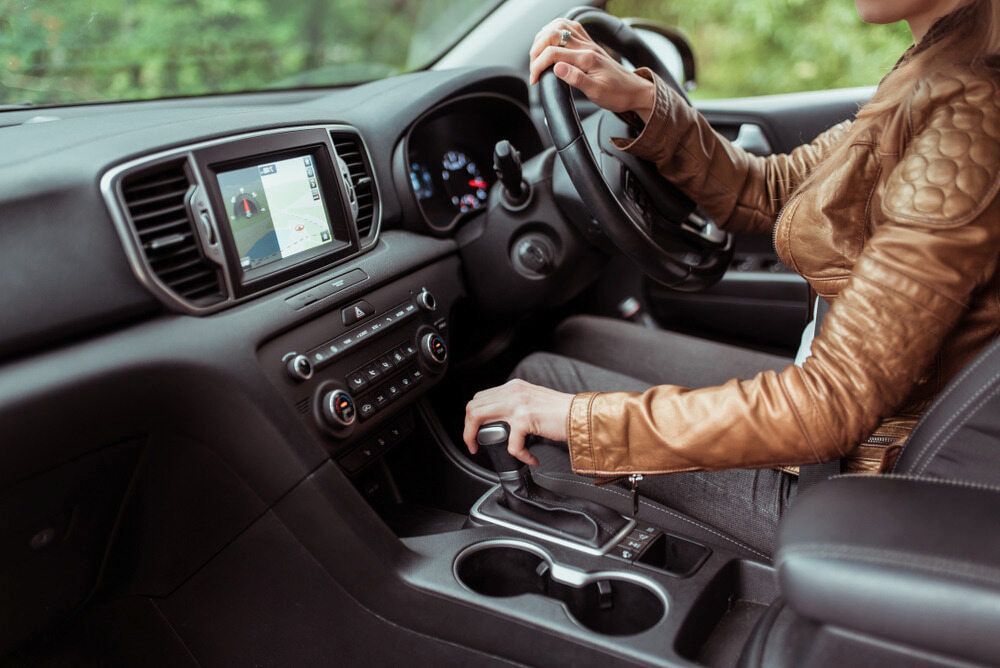 A Person Driving a Car, Hands on the Steering Wheel and Gear Shift — Cool Cars NT in Anula, NT