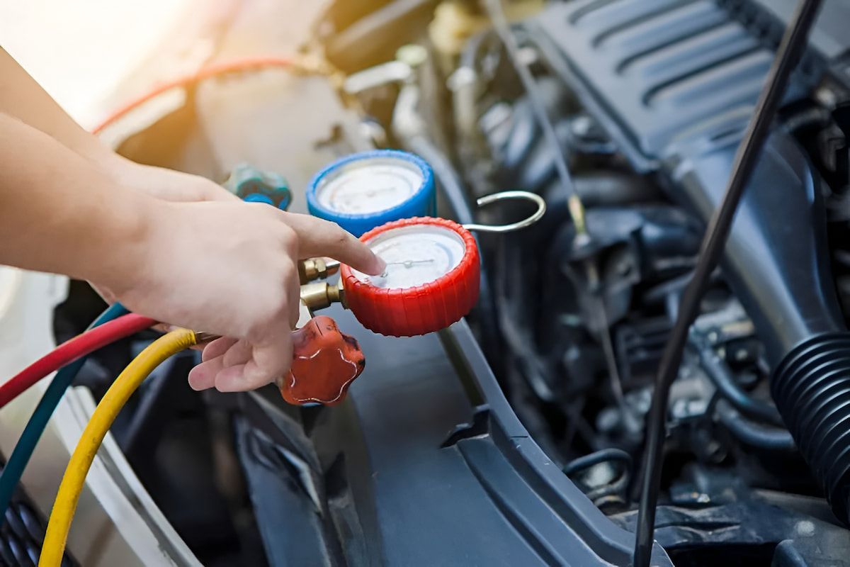 Person Using Gauges to Check a Car's Air Conditioning System Under the Hood — Cool Cars NT in Anula, NT