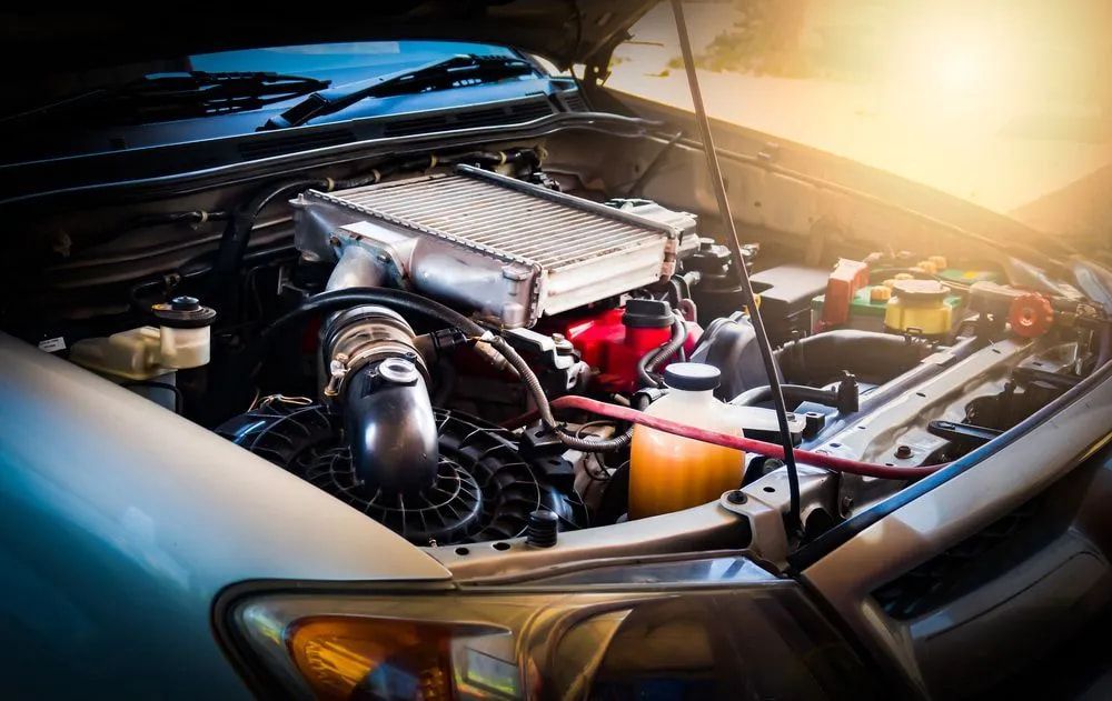 Car Engine Bay With Hood Open, Showing Engine Components Lit by Sunlight — Cool Cars NT in Anula, NT