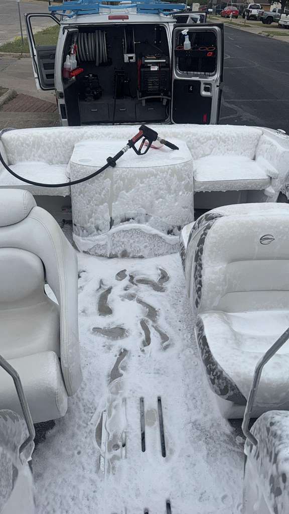 Snow-covered boat seats and deck with an open cabin in the background.