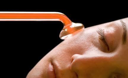 Orange suction cup touching a person’s closed eye on a black background