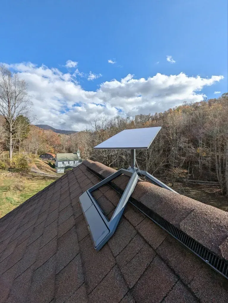 A solar panel is sitting on top of a roof.