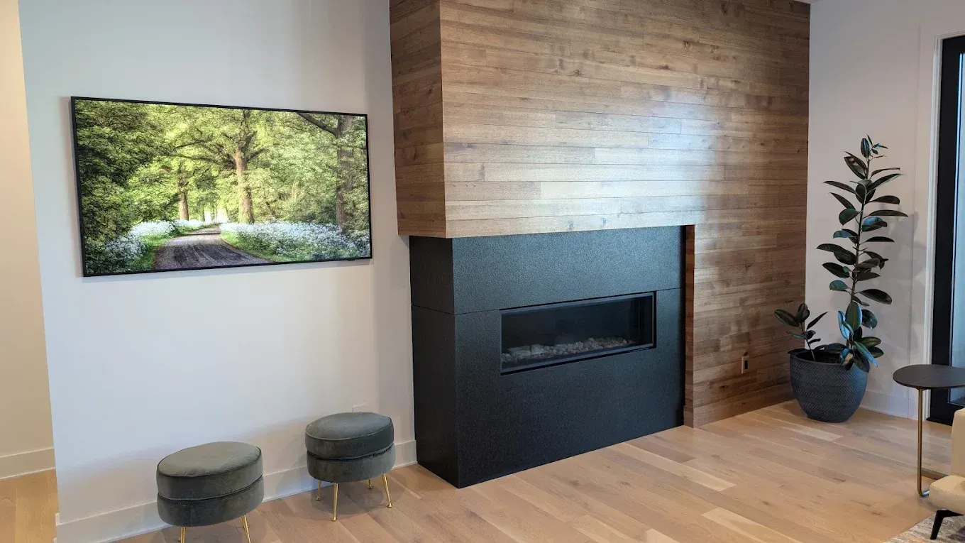 A living room with a fireplace and a flat screen tv.