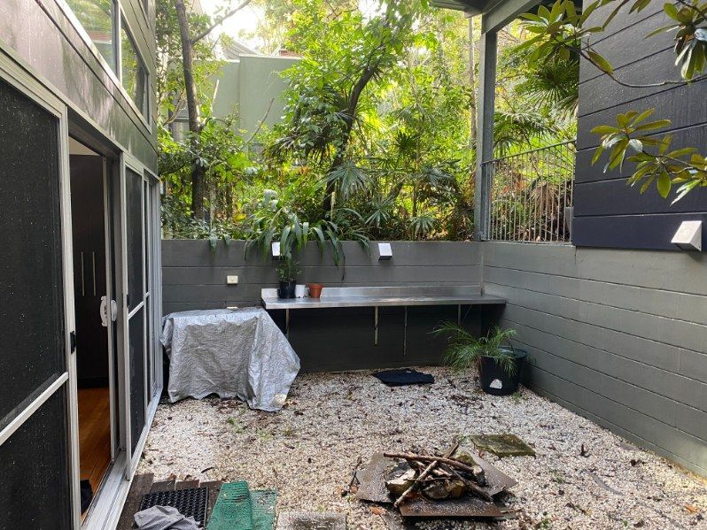 There Is A Fire Pit In The Backyard Of A House — The Guttering Cleaning Man in Taree, NSW