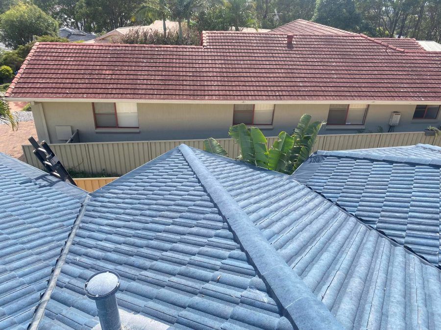 A roof of a house with a red tile roof.