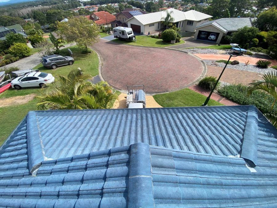 An aerial view of a house with a blue roof