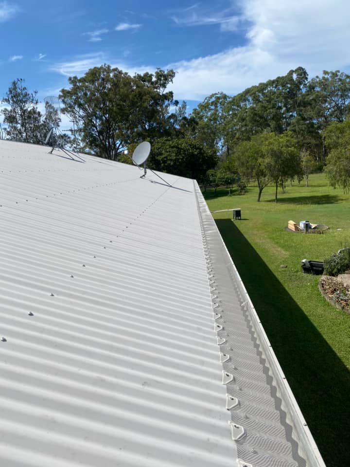 A white roof with a satellite dish on top of it