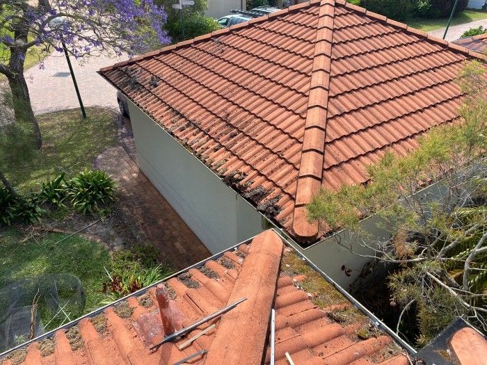 An Aerial View Of A Tiled Roof Of A House — The Guttering Cleaning Man in Forster, NSW