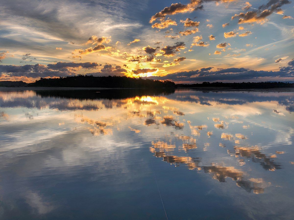 A Sunset Over A Lake With Clouds Reflected In The Water — The Guttering Cleaning Man in Old Bar, NSW
