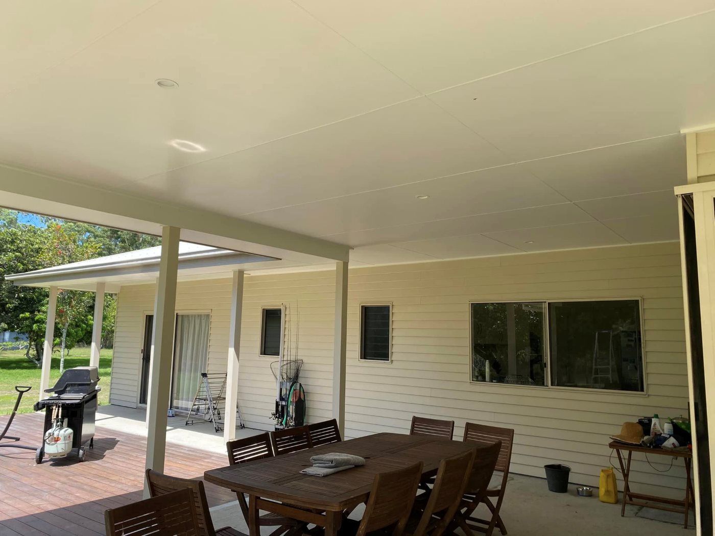 There Is A Table And Chairs On The Porch Of A House — The Guttering Cleaning Man in Forster, NSW