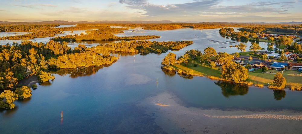 An Aerial View Of A Large Lake Surrounded By Trees — The Guttering Cleaning Man in Tuncurry, NSW