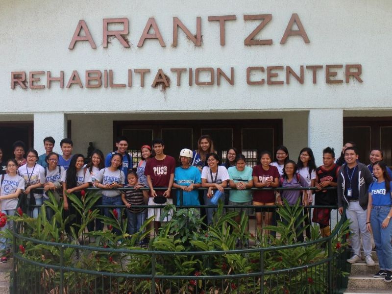 A group of people standing in front of the arantza rehabilitation center