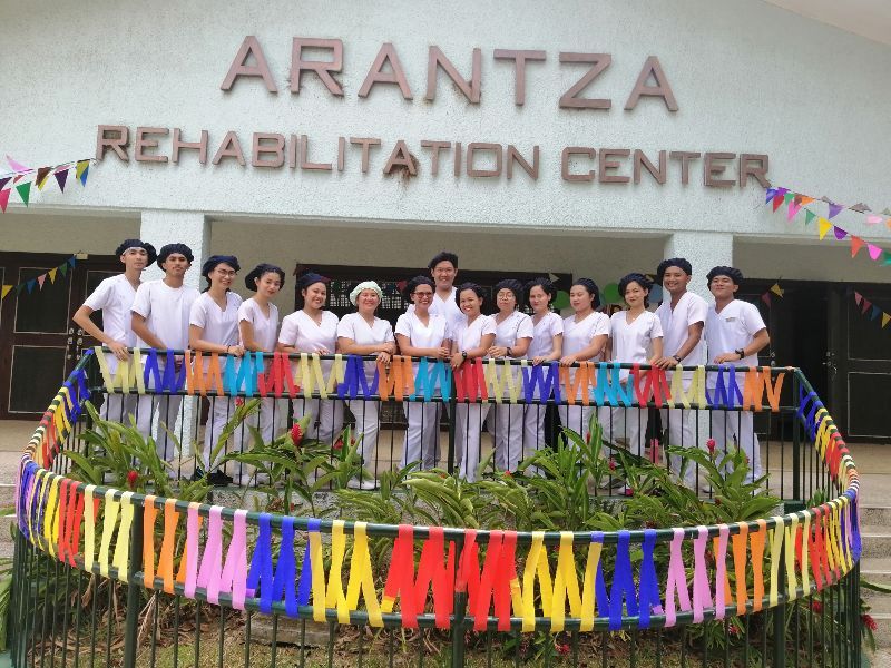 A group of people standing in front of the arantza rehabilitation center