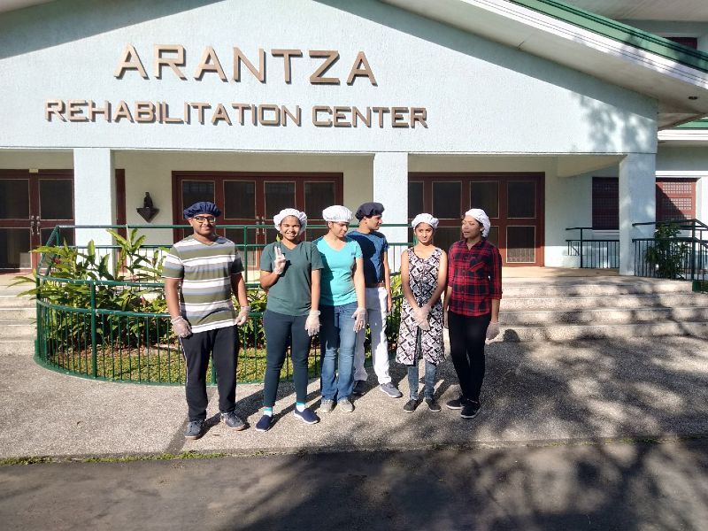 A group of people standing in front of the arantza rehabilitation center