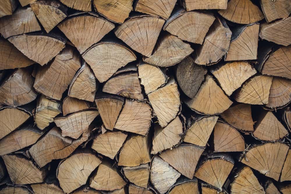 A Pile of Chopped Wood is Stacked on Top of Each Other — Perry's Timber & Fencing In Thirroul, NSW
