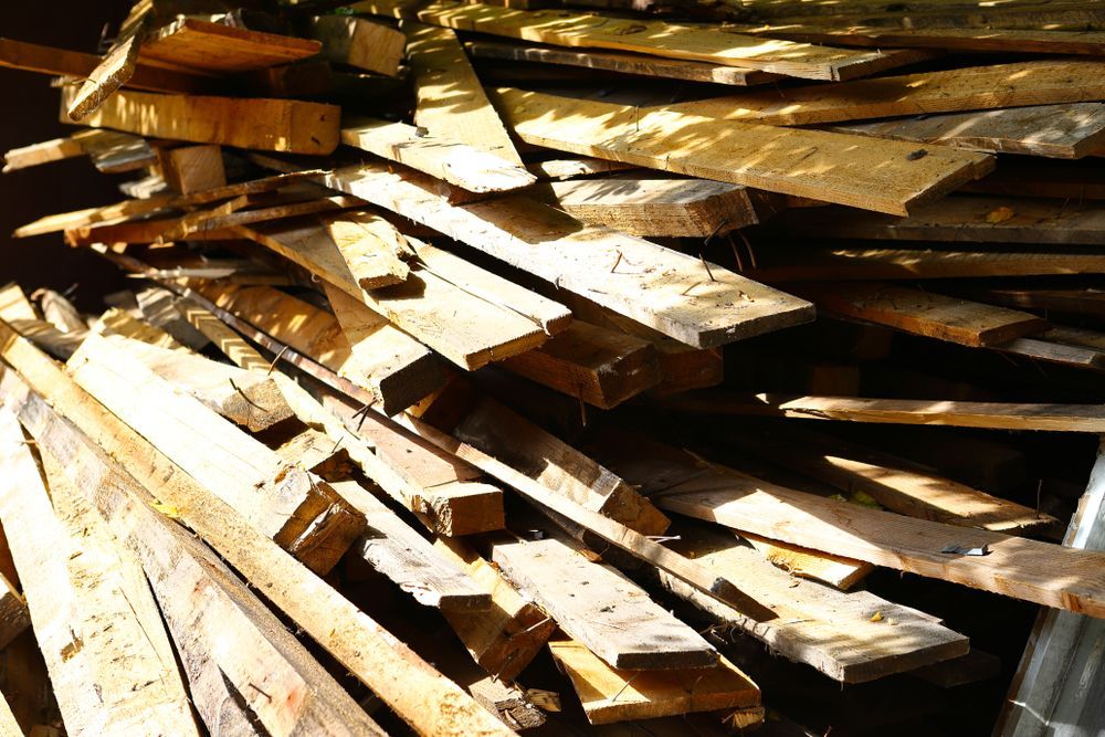 A Pile of Wood is Stacked on Top of Each Other — Perry's Timber & Fencing In Shellharbour, NSW