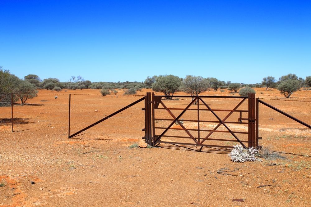 A Rusty Gate in the Middle of a Desert — Perry's Timber & Fencing In Kiama, NSW