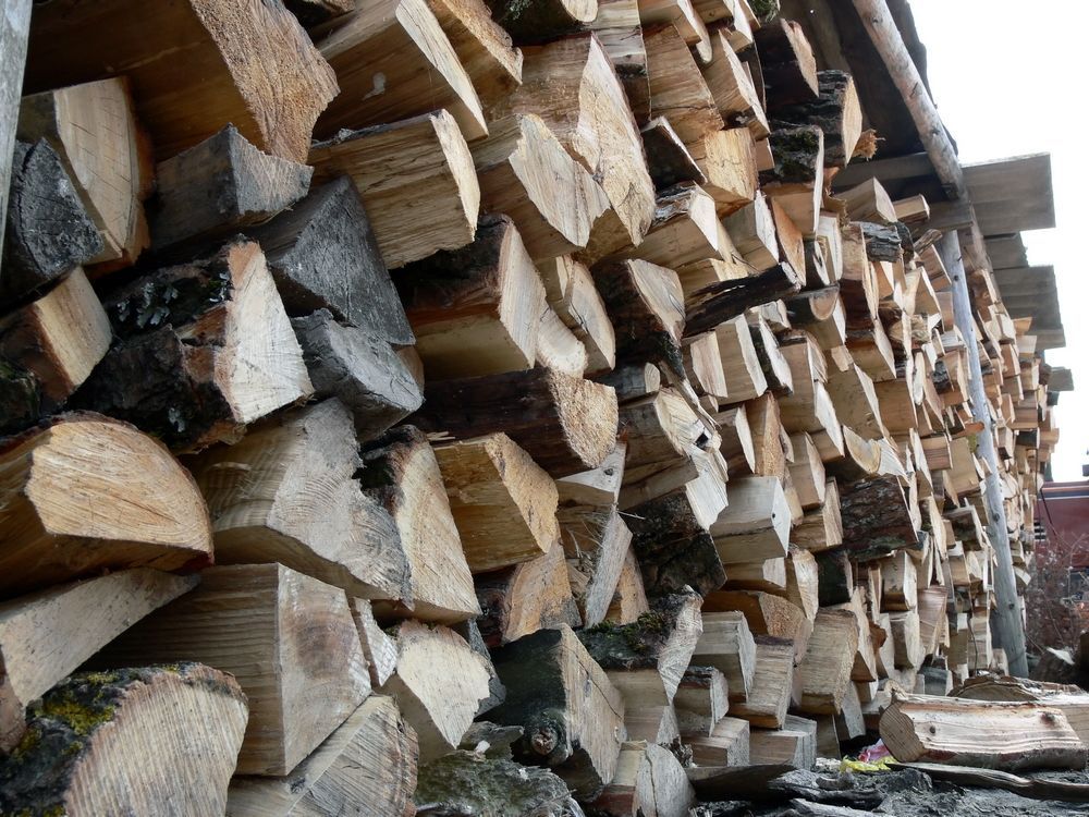 A Pile of Logs Stacked on Top of Each Other — Perry's Timber & Fencing In Kiama, NSW