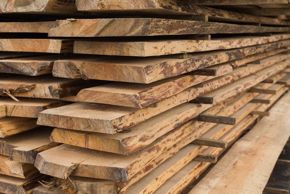 A Pile of Wooden Boards Stacked on Top of Each Other — Perry's Timber & Fencing In Dapto, NSW