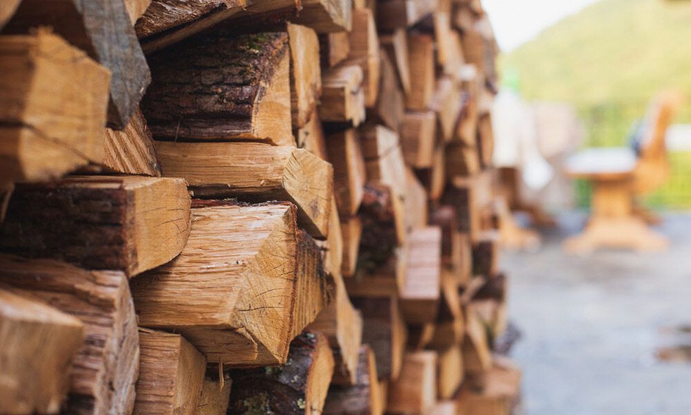 A Pile Of Wood Is Stacked On Top Of Each Other — Perry's Timber & Fencing In Dapto, NSW