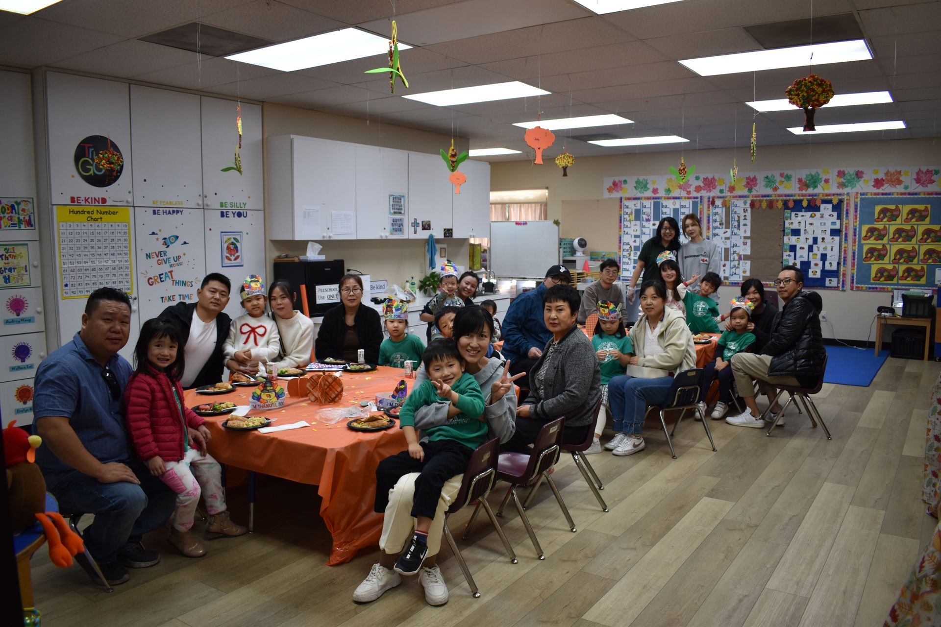 People seated around a table in a decorated room, likely for a gathering.