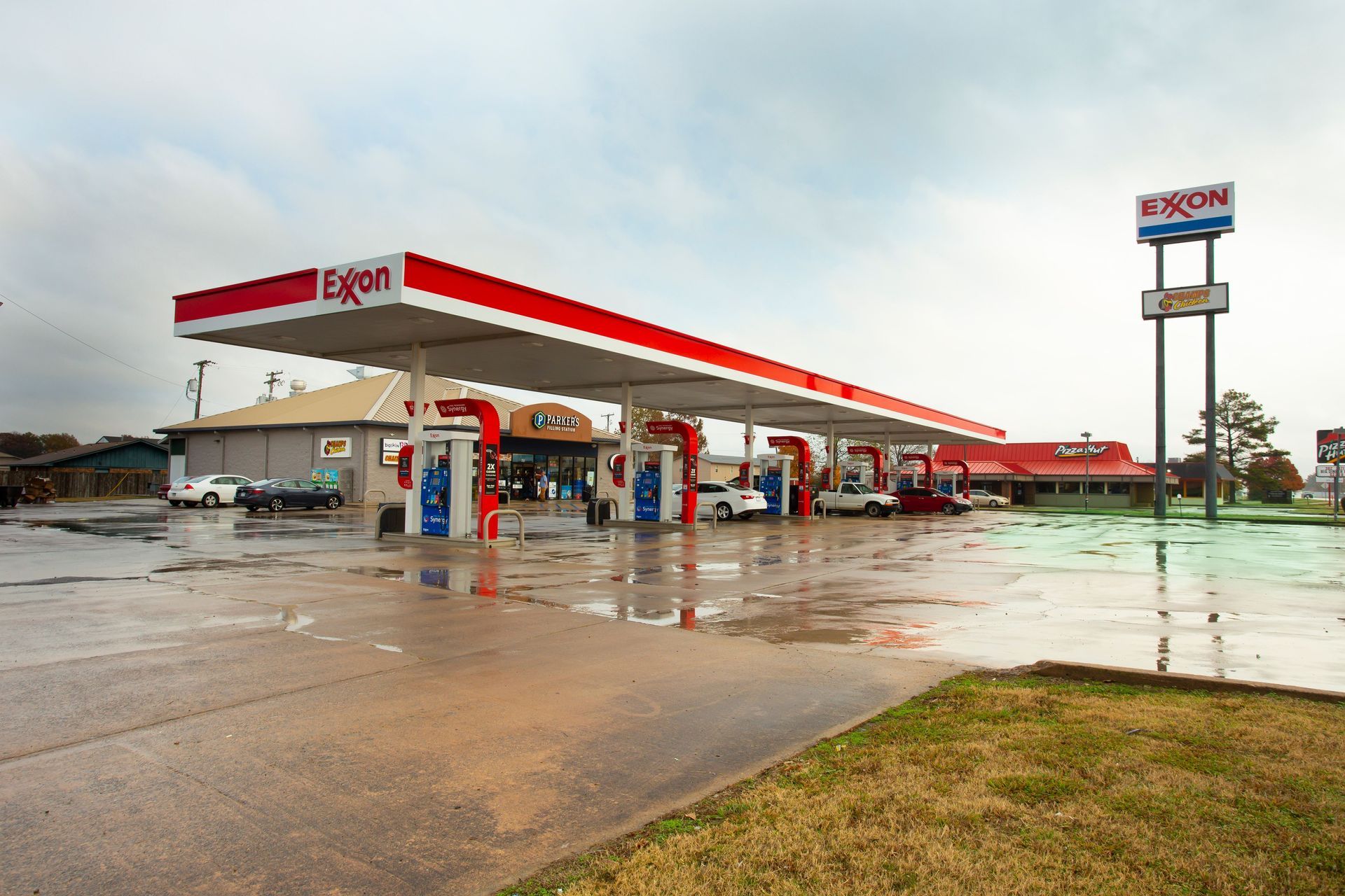 A red and white gas station with the word exxon on it