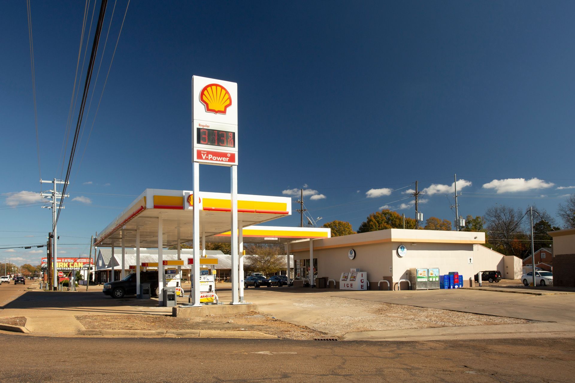 A shell gas station is located on the side of the road.
