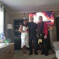 A group of people are posing for a picture in a living room.