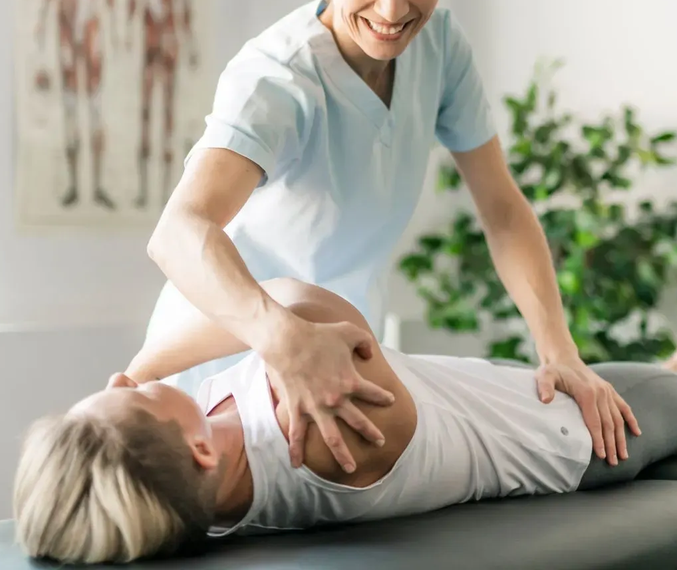 Physio treating a patient on a bed
