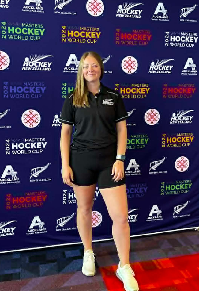Nerissa stabnding infront of Hockey logos