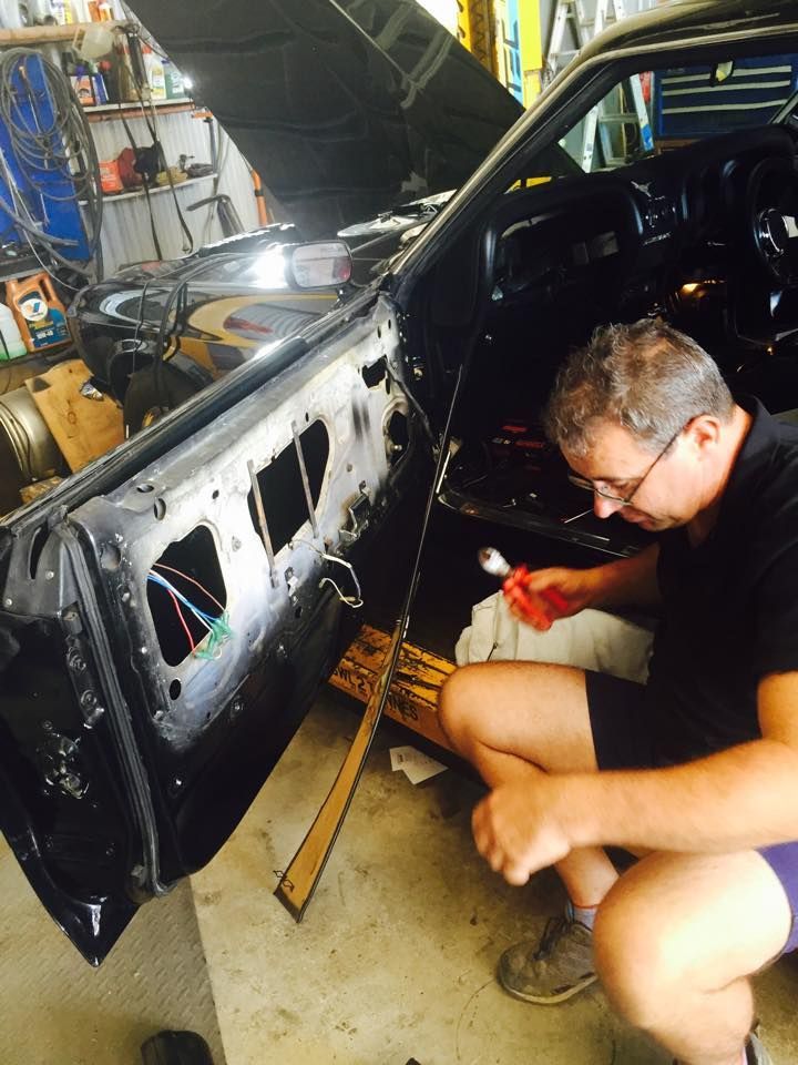 A Man is Working on a Car in a Garage — Cairns Auto Electrical Mechanical Air & Audio in Mareeba, QLD