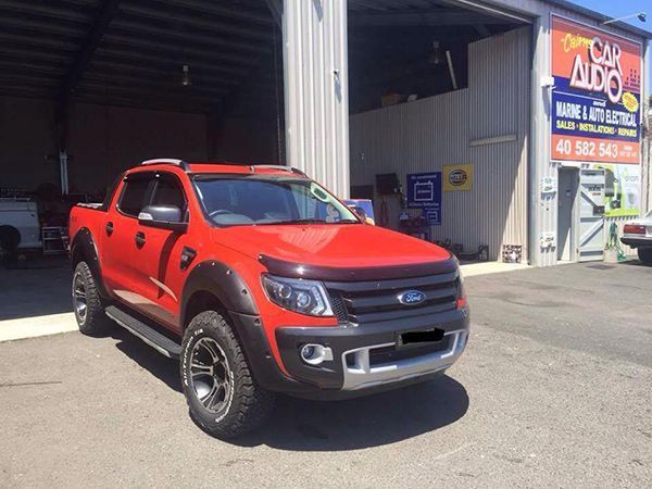 A Red Ford Truck is Parked in Front of a Garage — Cairns Auto Electrical Mechanical Air & Audio in Mareeba, QLD