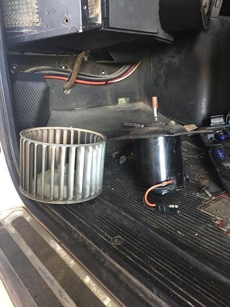 A Blower Wheel is Sitting Next to a Motor in a Car — Cairns Auto Electrical Mechanical Air & Audio in Mareeba, QLD