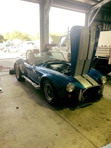 A Blue and White Sports Car is Parked in a Garage — Cairns Auto Electrical Mechanical Air & Audio in Stratford, QLD