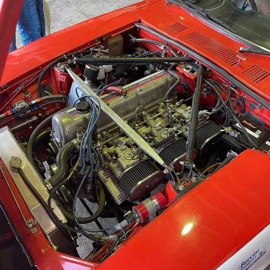 The Engine of a Red Car is Visible Under the Hood — Cairns Auto Electrical Mechanical Air & Audio in Stratford, QLD