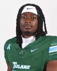 Tulane football player in green jersey and white headband, posing against a plain background
