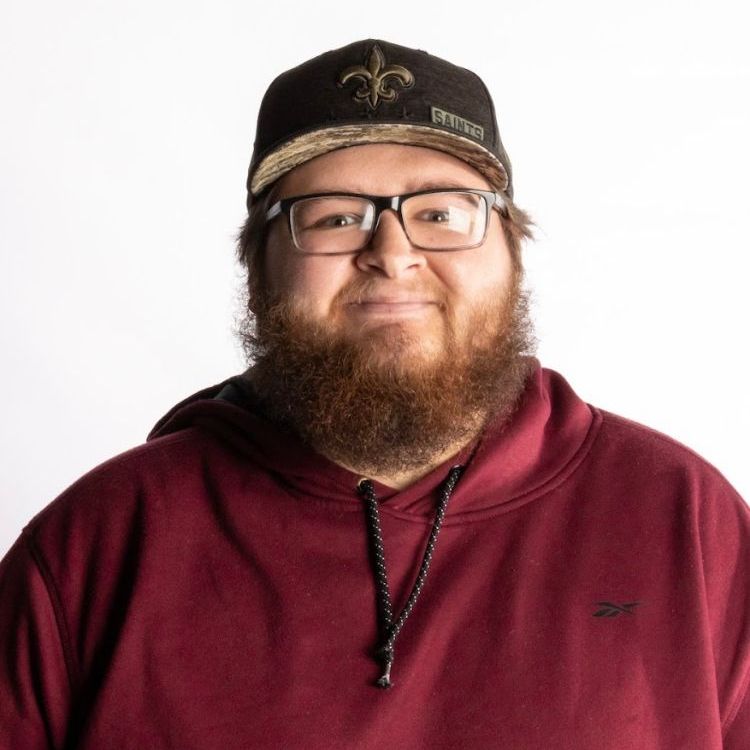 A man with a beard wearing a hat and glasses