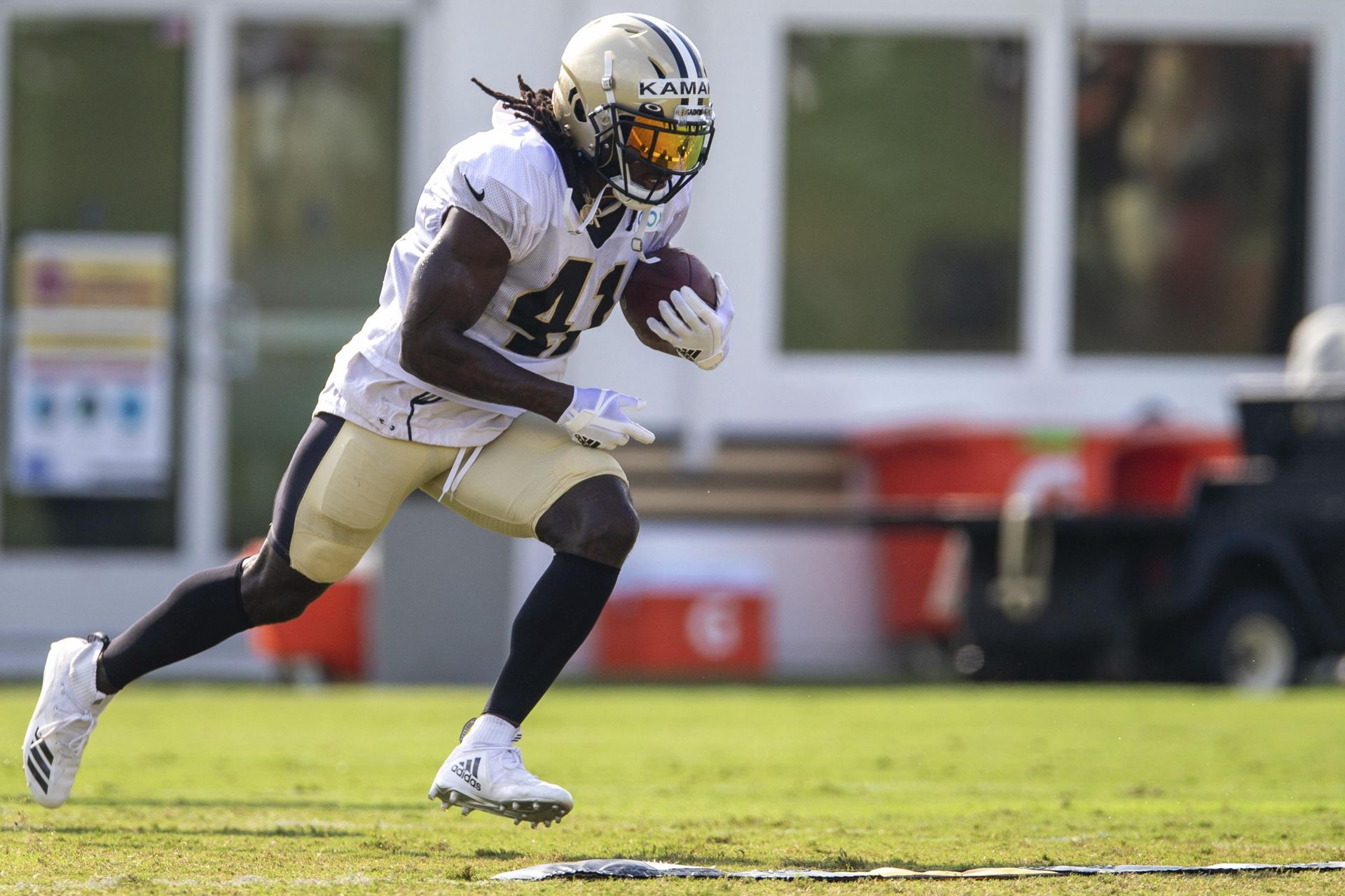 A football player is running with the ball on a field.