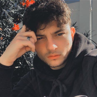 A man with a beard wearing a black hoodie with the word geek on it