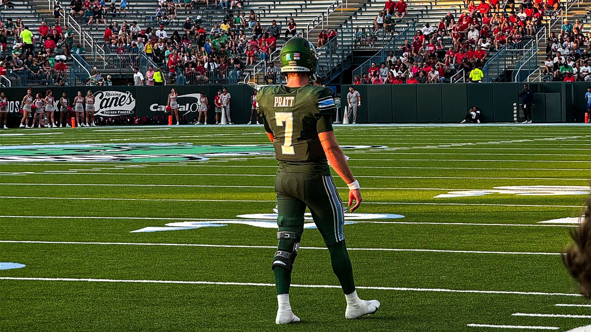 A football player with the number 7 on his jersey is standing on the field.