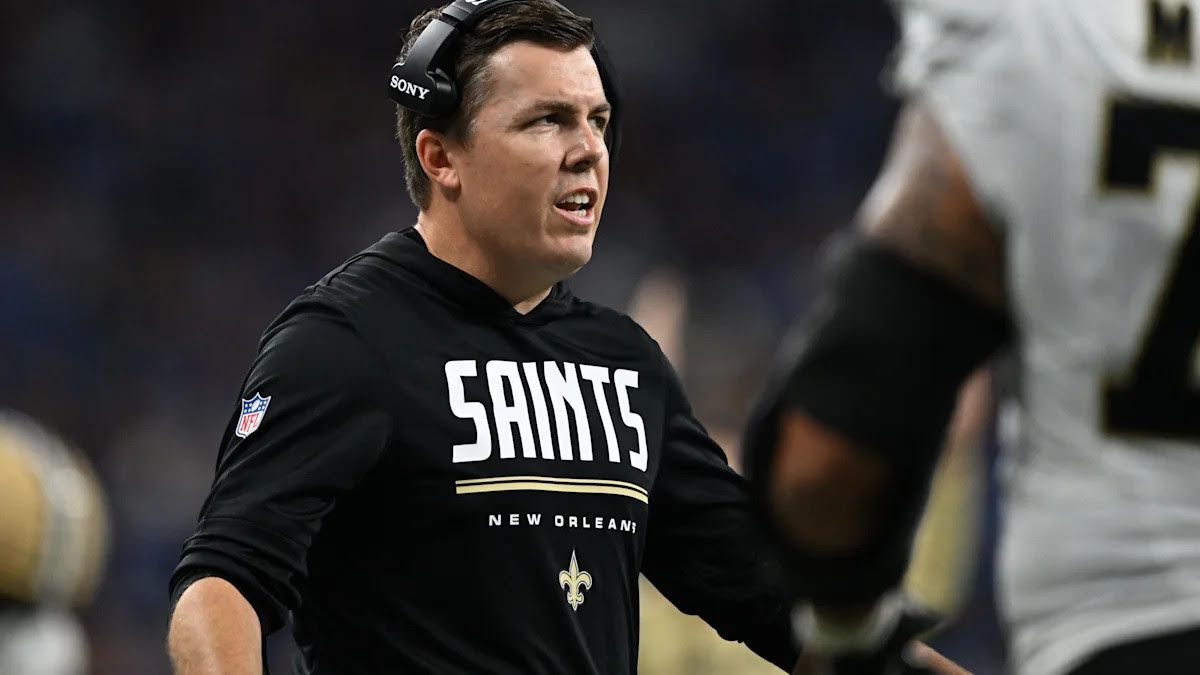 New Orleans Saints coach in black sweatshirt and headset on the sideline during a game