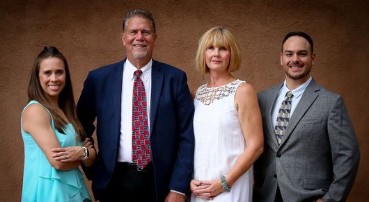 A group of people in suits and ties are posing for a picture.