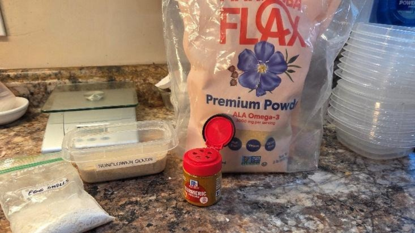 Flax seed bag, red-lidded spice jar, and stacked disposable plates on a kitchen counter