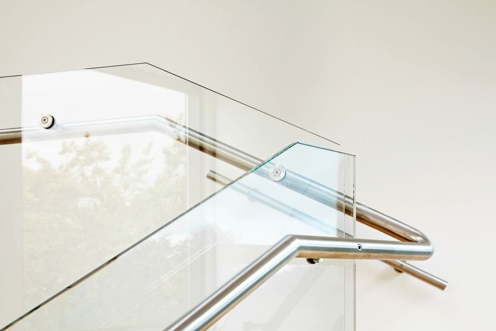 A Glass Balustrade Leading Up Stairs With Wooden Frame — Waratah Home Improvements in Coledale, NSW