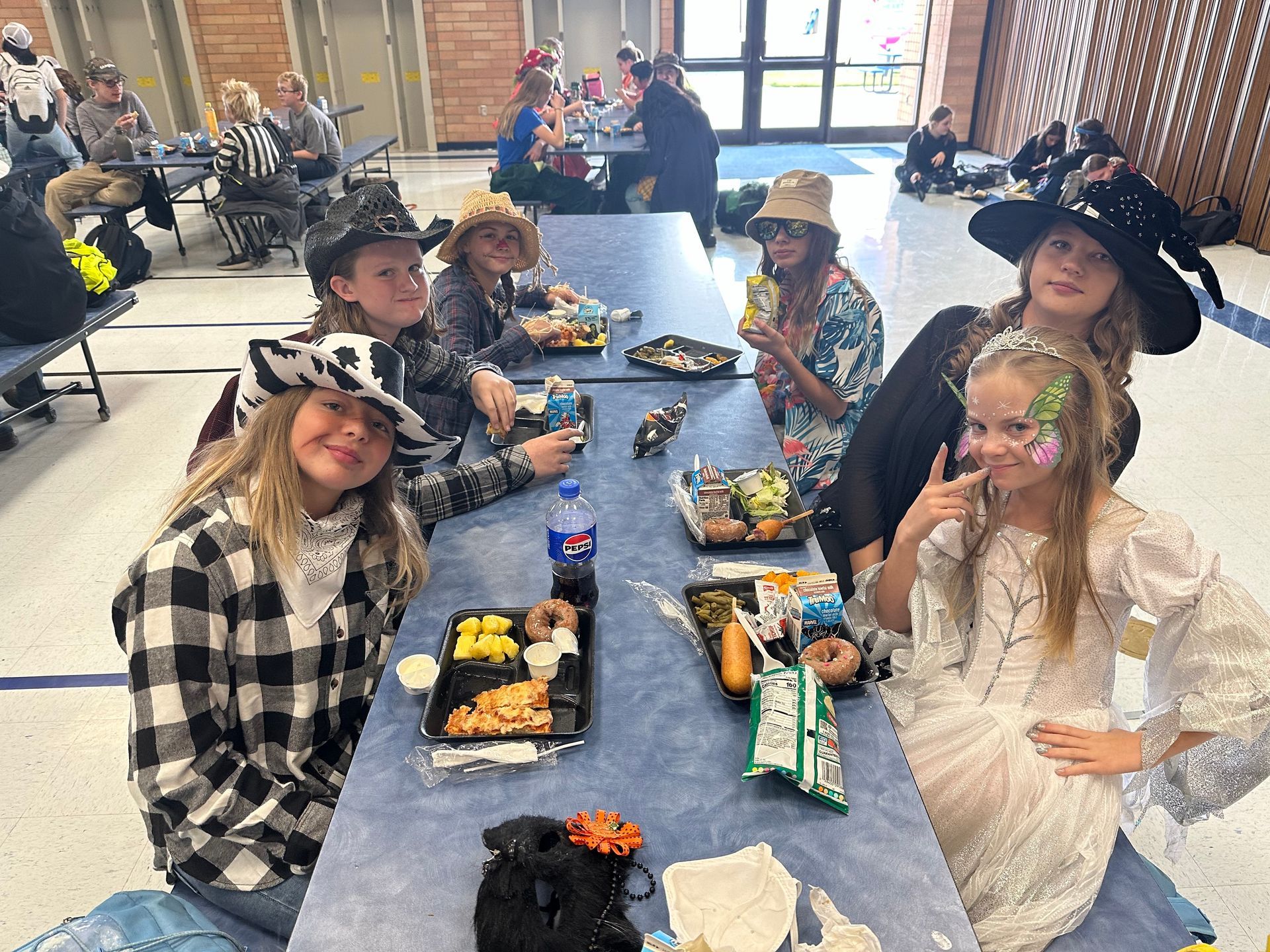 Group of students during lunch sitting at table on Halloween