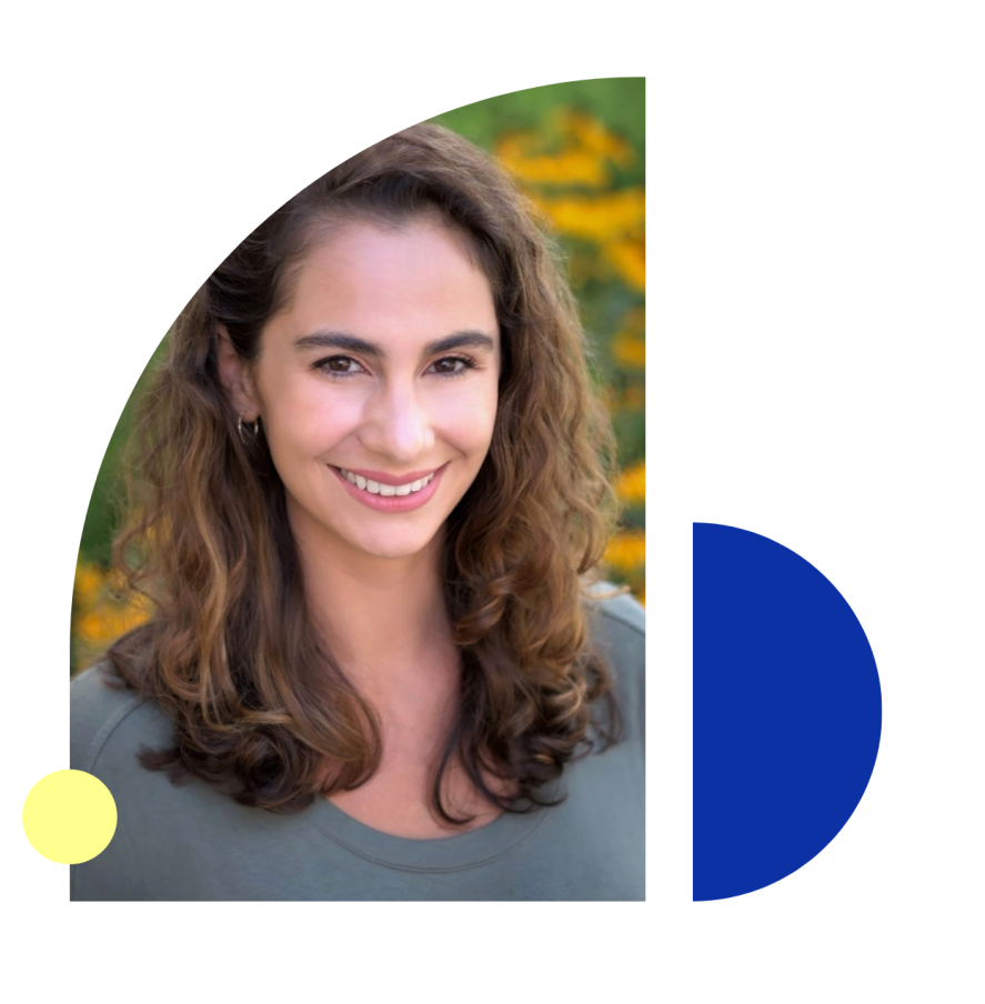 Smiling woman with long brown hair in a green shirt against a yellow and blue design.