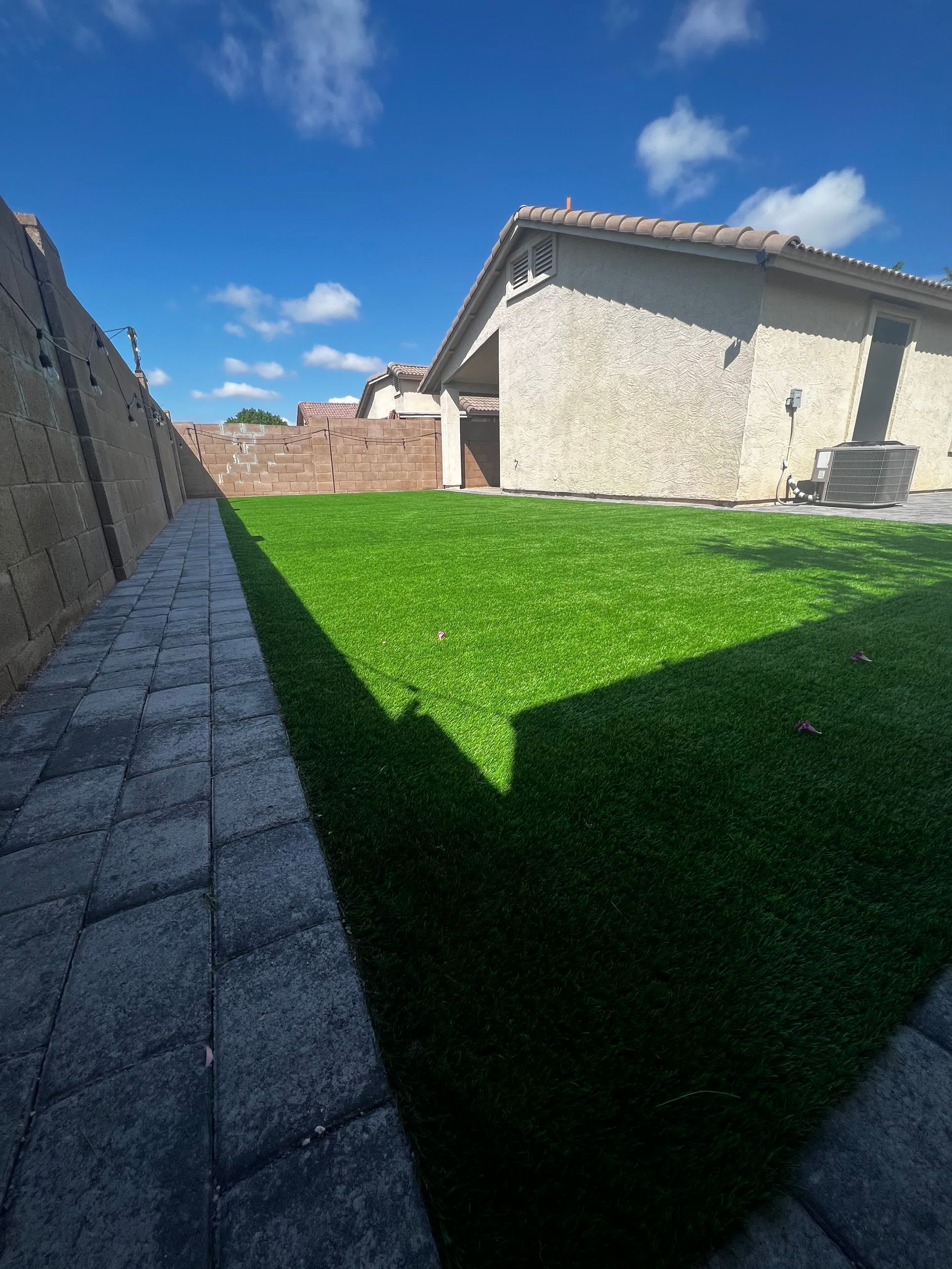 A house with a large lawn in front of it.